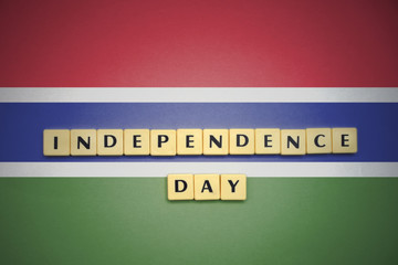 letters with text independence day on the national flag of gambia.