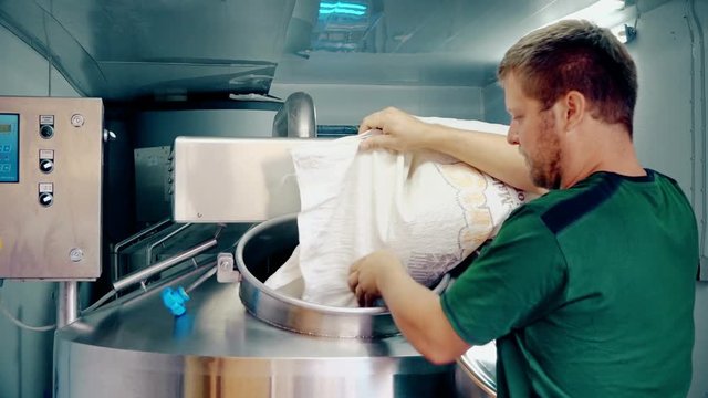 Man pouring barley into mash tun
