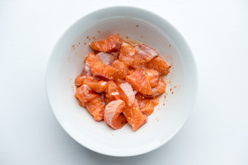 Raw Salmon with spicy sauce in bowl.
