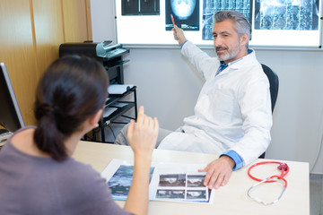 Radiologist pointing to images