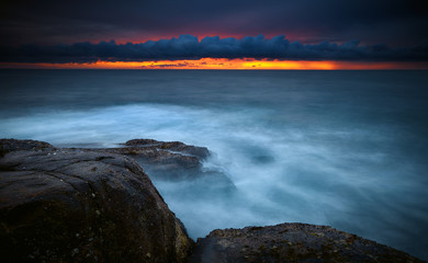Beautiful sunset with red sun and ocean