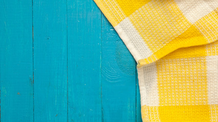 yellow towel in a cage on a blue wooden background