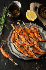 Delicious grilled shrimp with lemon, spices and sauce
