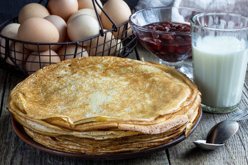 A stack of pancakes with sour cream