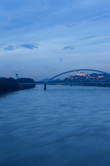 Obraz premium Old town, riverside, Bratislava castle, Apollo Bridge, UFO Bridge, New Bridge shoot during dusk from above river Danube, Slovakia