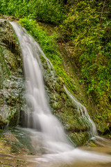 Fototapeta na wymiar Little waterfall in the wilderness.