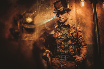 steampunk style man with various mechanical devices on vintage steampunk background