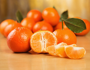 Many fresh mandarins on a wooden surface