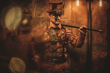 steampunk style man with various mechanical devices on vintage steampunk background