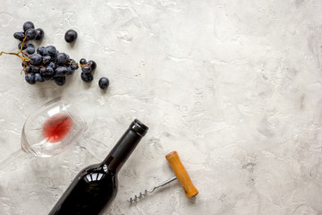 bottle of red wine and corkscrew on stone background top view mockup