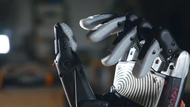 Real innovative bionic cybernetic man gesturing. Futuristic arm moving fingers. 4K.