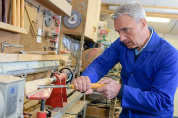 senior carpenter working at workshop