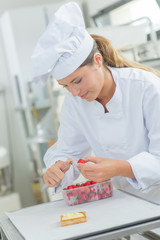 Chef preparing strawberries to decorate a tart