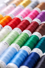 Background from spools with multicolored sewing threads