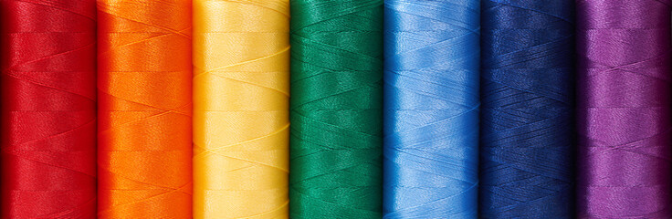 Multicolored sewing threads arrange like rainbow