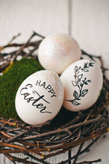 Beautiful Easter background with eggs in the nest and wishes for a happy Easter