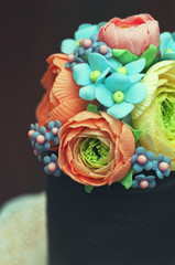 Fototapeta premium Clos-up view of homemade cake with sugar paste edible floral decorations.