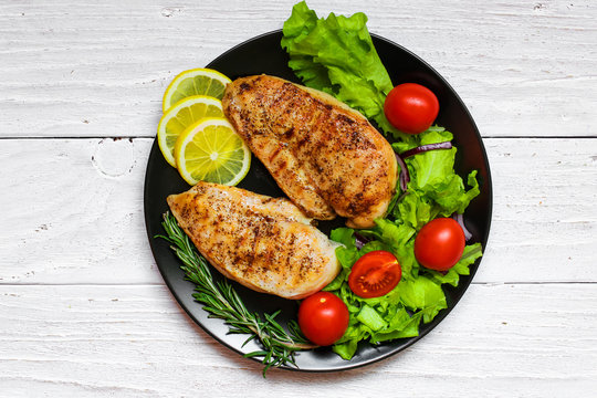 Grilled Chicken Breast With Green Salad, Tomatoes, Lemon And Ros