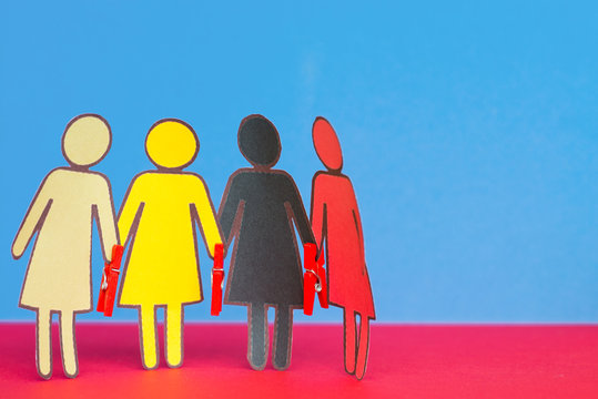 Paper Group of Women of different races holding hands with paperclips - Powered by Adobe