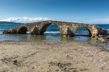 Seascape with medieval bridge in the water at Argassi beach, Zakynthos island, Greece