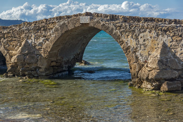 Fototapeta na wymiar Seascape with medieval bridge in the water at Argassi beach, Zakynthos island, Greece