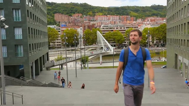 Young male tourist  walking, viewing places of interest in Bilbao city center