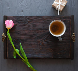Mother's Day, woman's day. tulips ,presents ,tea and sweets on wooden background