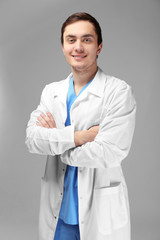 Young doctor on white background