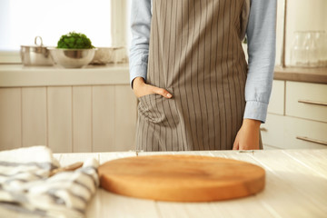 Woman wearing apron in kitchen