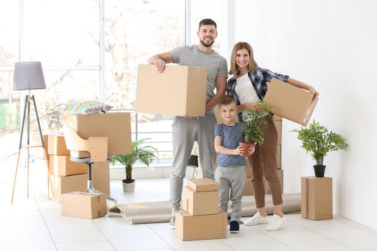 Happy family with cardboard boxes. Moving concept