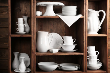 Wooden shelves with white rustic dinnerware