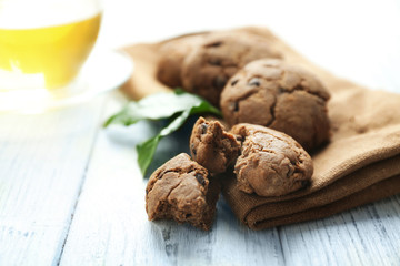 Delicious coffee cookies and cup of tea on wooden table