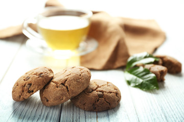 Delicious coffee cookies and cup of tea on wooden table