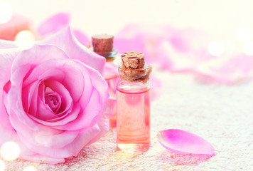 Obraz na płótnie Canvas Bottles of essential rose oil for aromatherapy. Rose spa concept