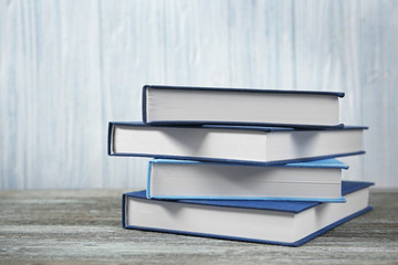 Books stacked on wooden background