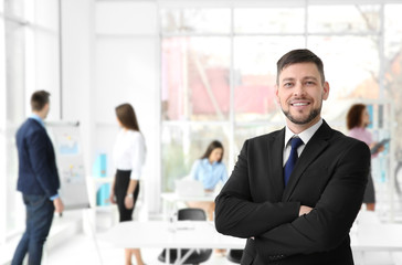 Businessman with crossed hands in office