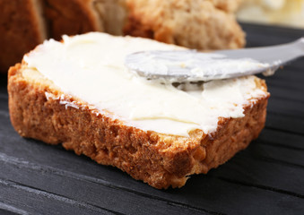 Slice of tasty beer bread on wooden board