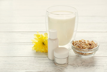 Milk and cosmetics on wooden background