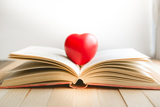 red heart on open book with copy space in relaxation and cozy mood, Image for education, love and brightness  concept