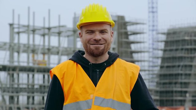 Happy, smiling construction worker on site