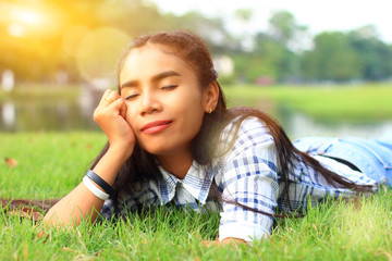 woman dreaming happily on grass in the park
