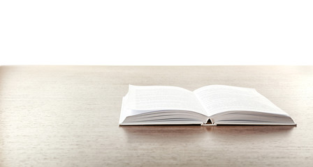 Open book on wooden table