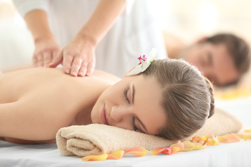 Fototapeta na wymiar Young beautiful woman having massage in spa salon