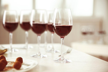 Red wine and delicious chocolate truffles on white table