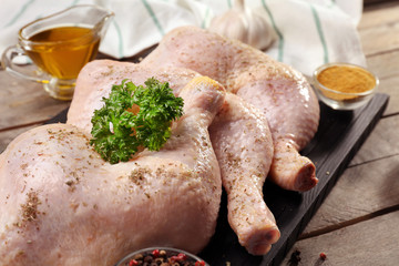 Raw chicken thighs with spices, closeup