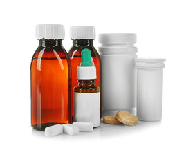 Bottles with cough syrup, pills and medicines isolated on white