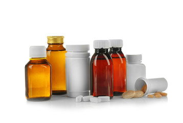 Bottles with cough syrup, pills and medicines isolated on white