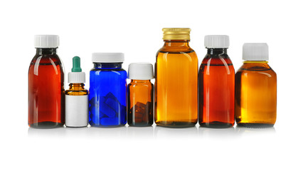 Bottles with cough syrup, pills and medicines isolated on white