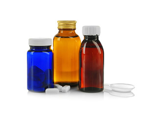 Bottles with cough syrup and pills isolated on white