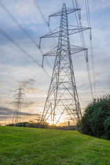 Electricity Pylon - UK standard overhead power line transmission tower at sunset